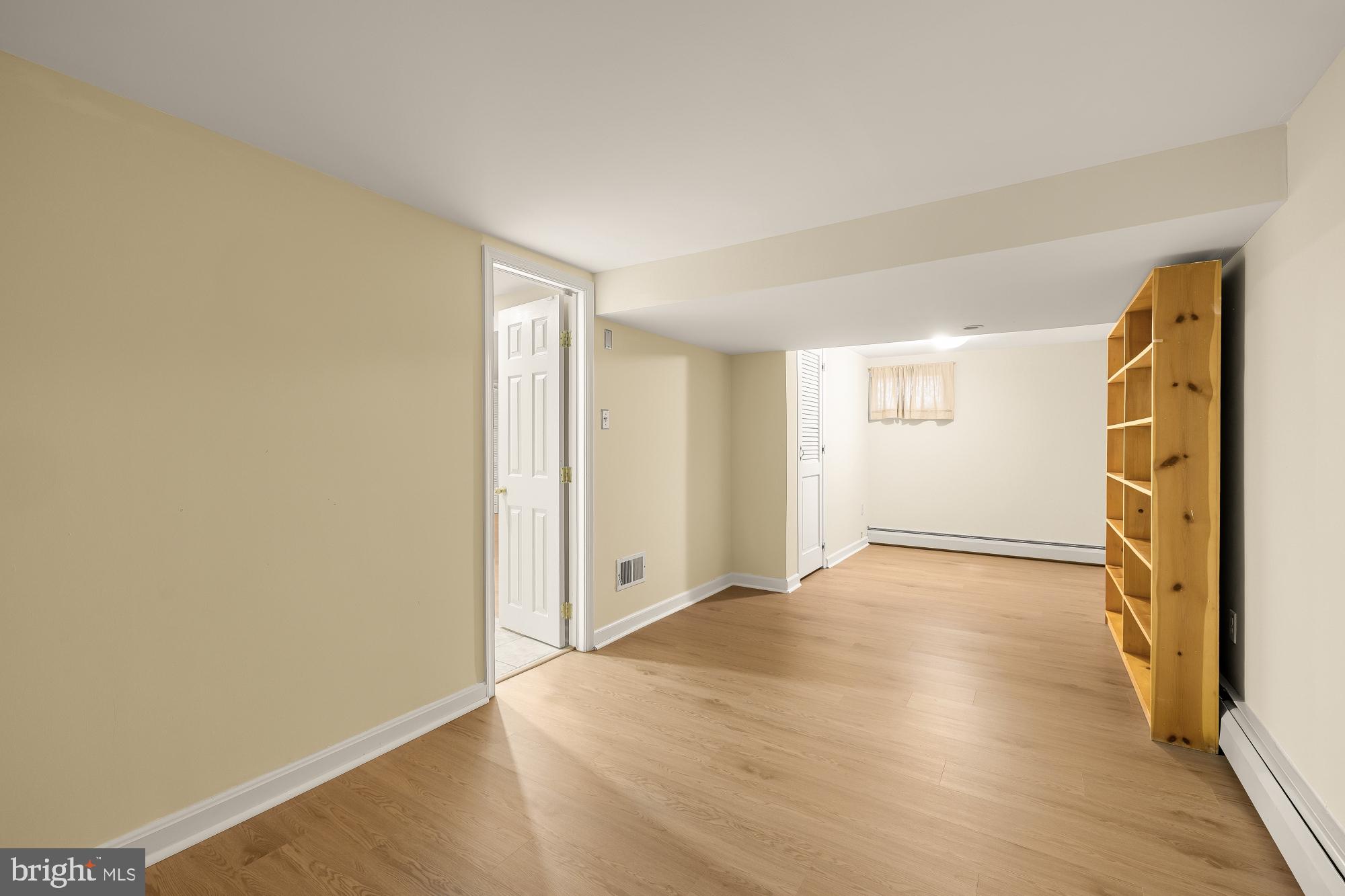6112 Madawaska Road Bethesda, MD 20816 - Photo 43 of 56 a view of an empty room with wooden floor and a window