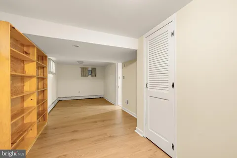 a roof deck view with a table and chairs under an umbrella