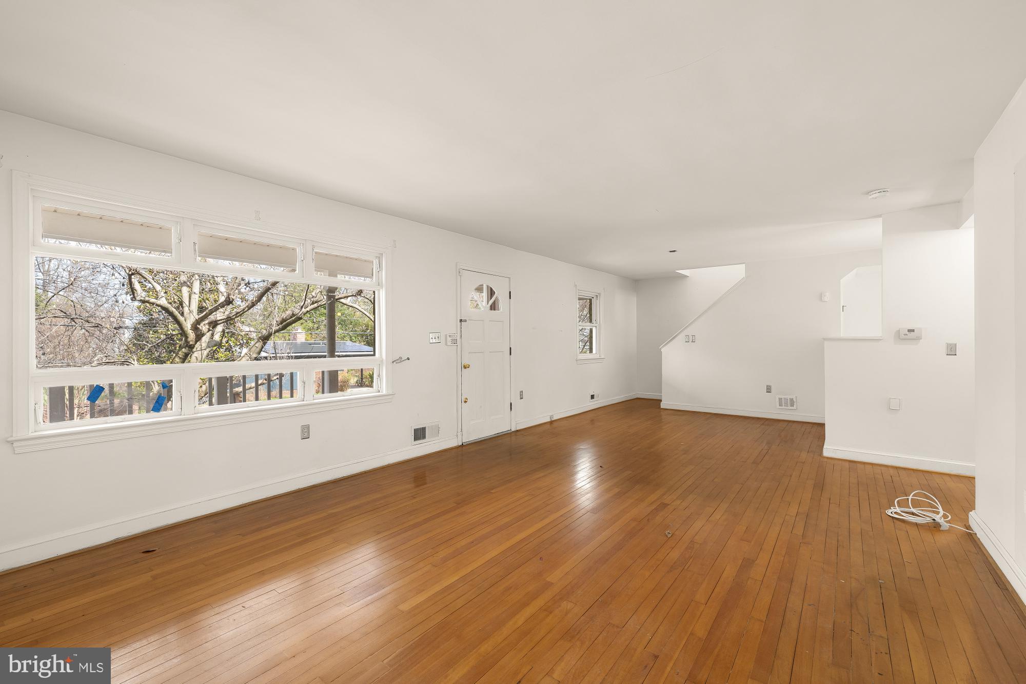 6112 Madawaska Road Bethesda, MD 20816 - Photo 8 of 56 an empty room with wooden floor and windows