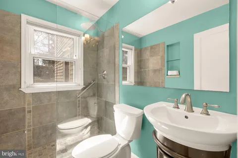 a bathroom with a toilet a sink and shower