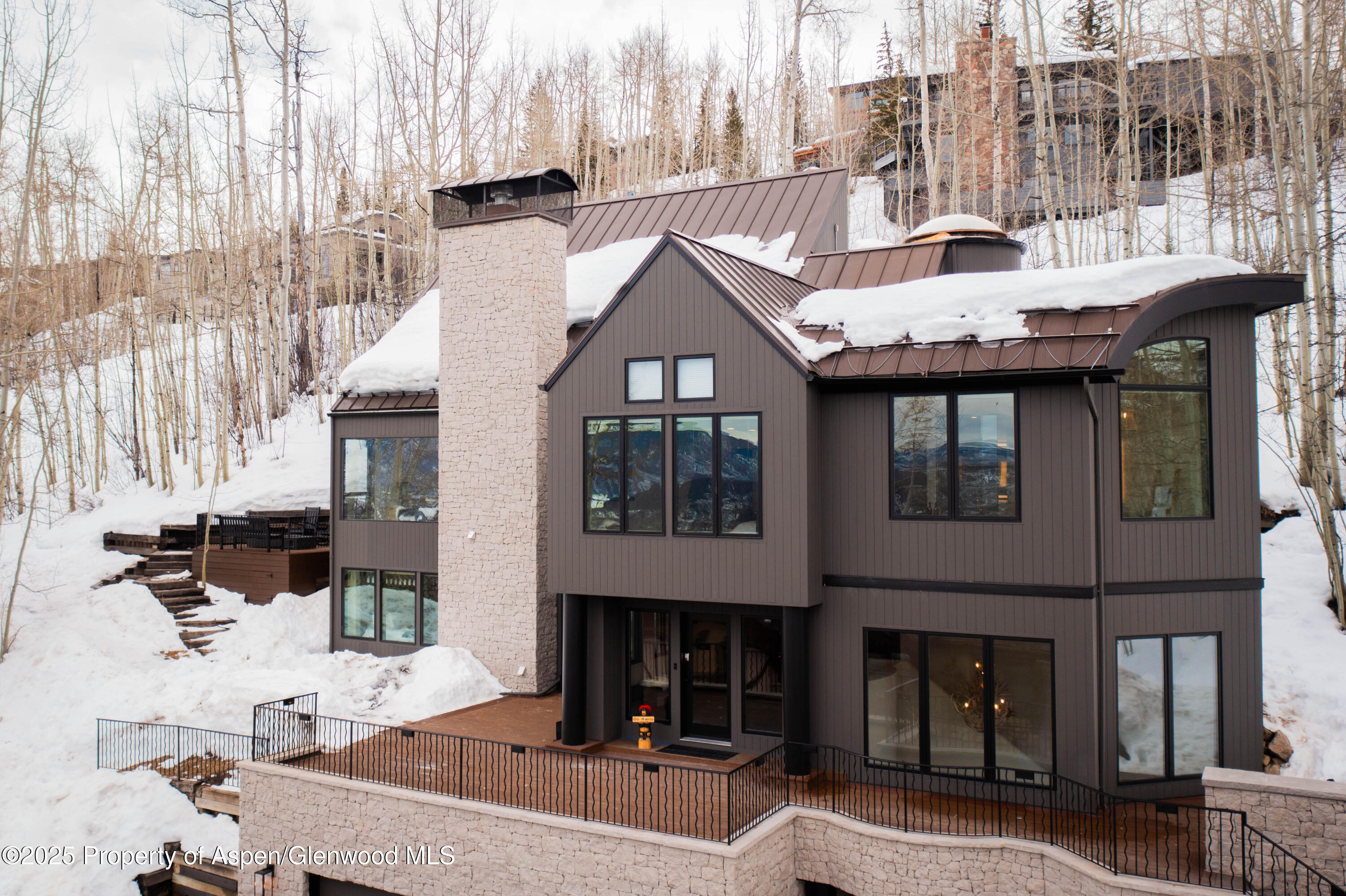 306 Edgewood Lane Snowmass Village, CO 81615 - Photo 1 of 41 a front view of a building with a yard