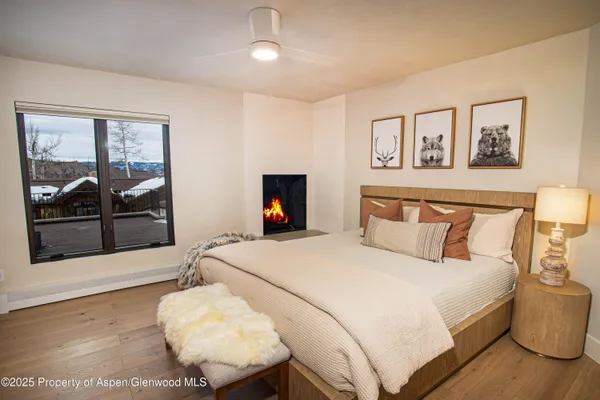a bedroom with a bed and a large window