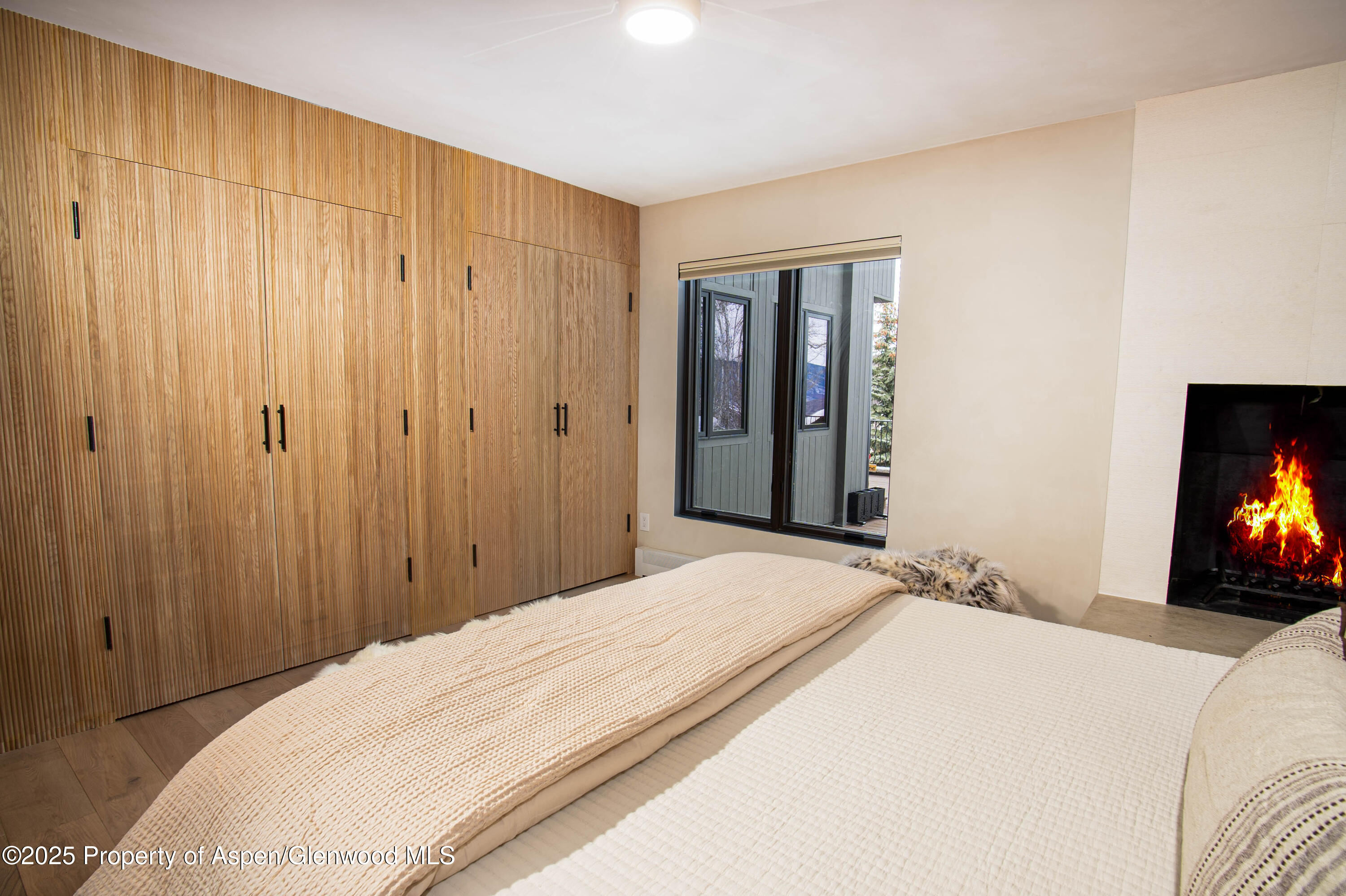 306 Edgewood Lane Snowmass Village, CO 81615 - Photo 15 of 41 a bedroom with a bed and a flat screen tv