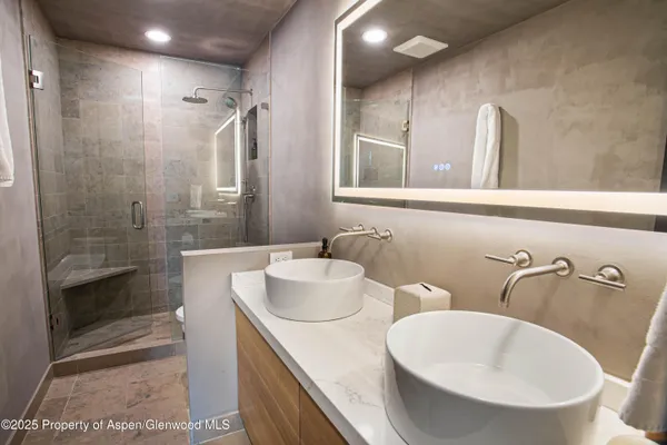 a bathroom with 2 sink and a bathtub