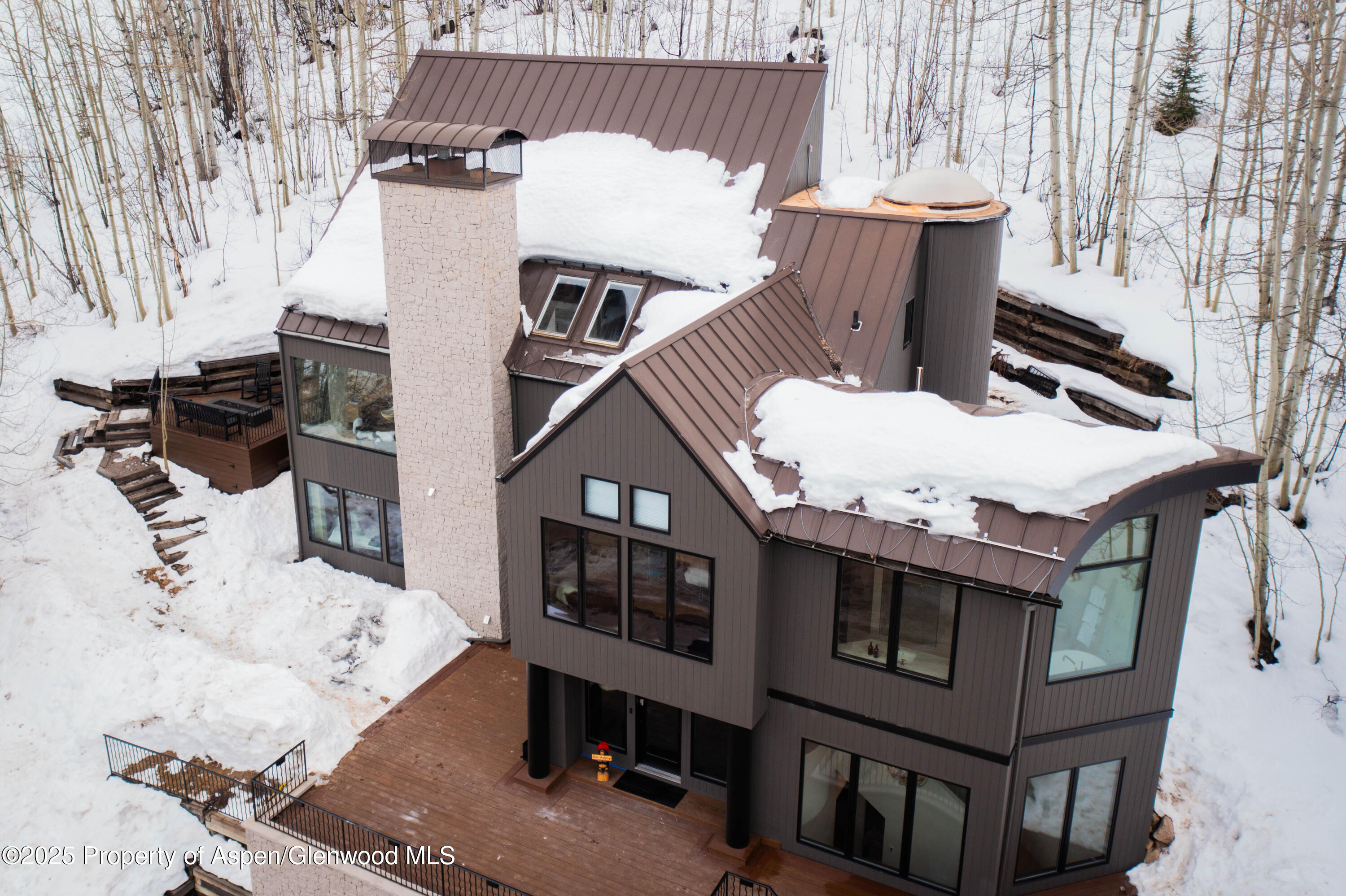 306 Edgewood Lane Snowmass Village, CO 81615 - Photo 2 of 41 a view of a house with a chairs and table in a patio