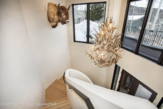 a dining room with furniture and a floor to ceiling window