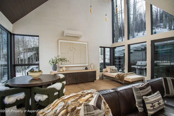 a living room with furniture and large windows