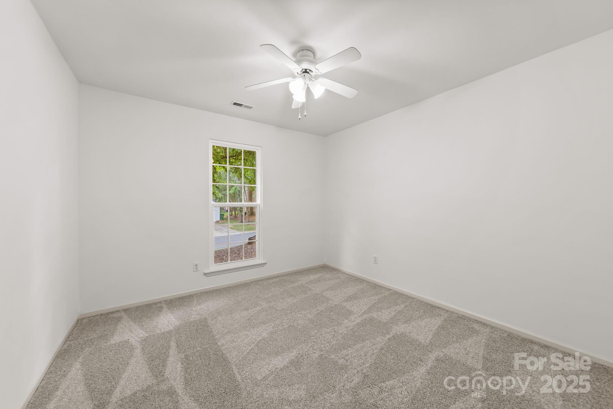 8806 Golf Ridge Drive Charlotte, NC 28277 - Photo 12 of 22 an empty room with windows and fan