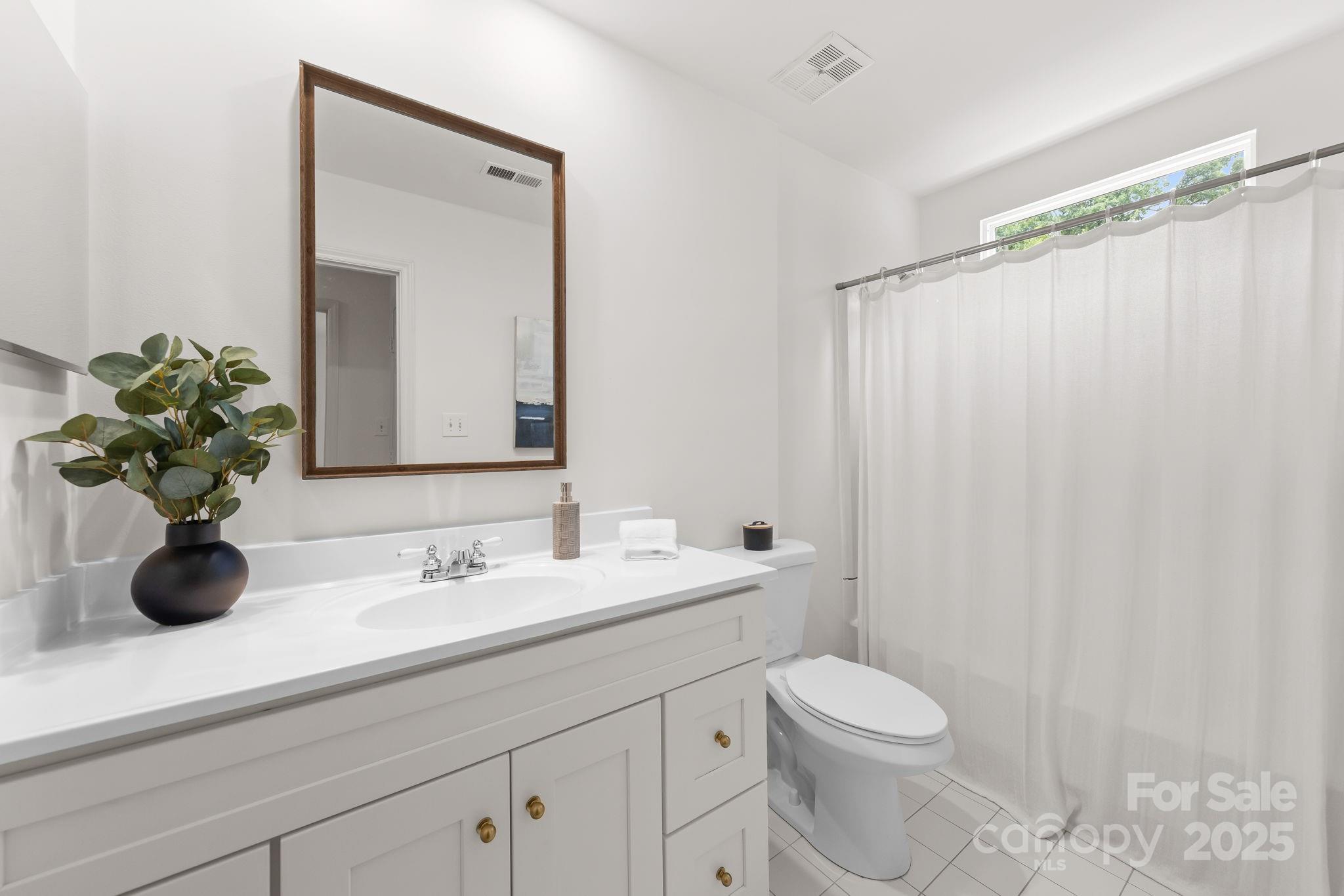 8806 Golf Ridge Drive Charlotte, NC 28277 - Photo 14 of 22 a bathroom with a toilet a sink and mirror