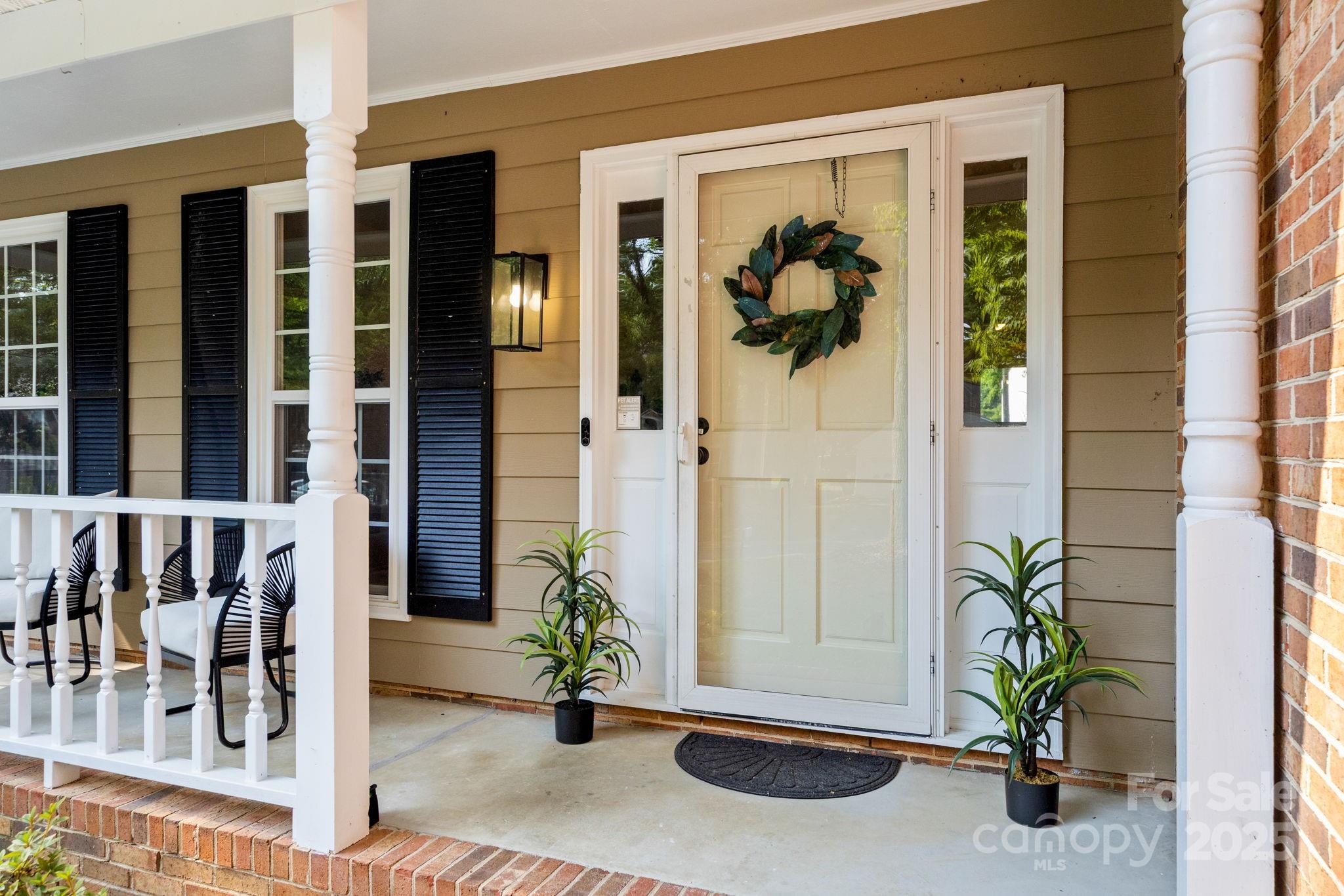 8806 Golf Ridge Drive Charlotte, NC 28277 - Photo 2 of 22 a front view of a house with a potted plant