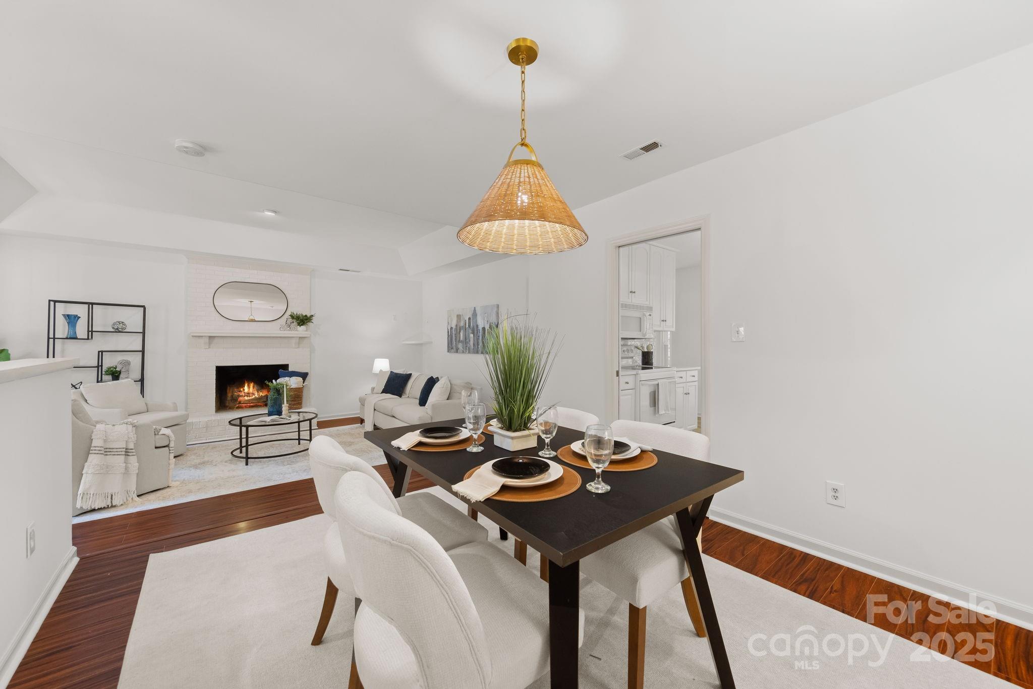 8806 Golf Ridge Drive Charlotte, NC 28277 - Photo 6 of 22 a living room with furniture a fireplace and a chandelier