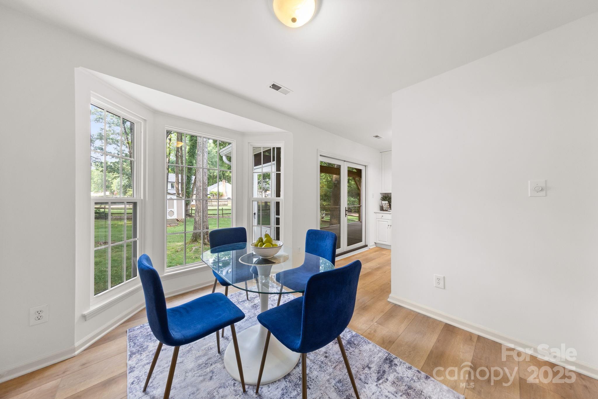8806 Golf Ridge Drive Charlotte, NC 28277 - Photo 9 of 22 a dining room with furniture and wooden floor