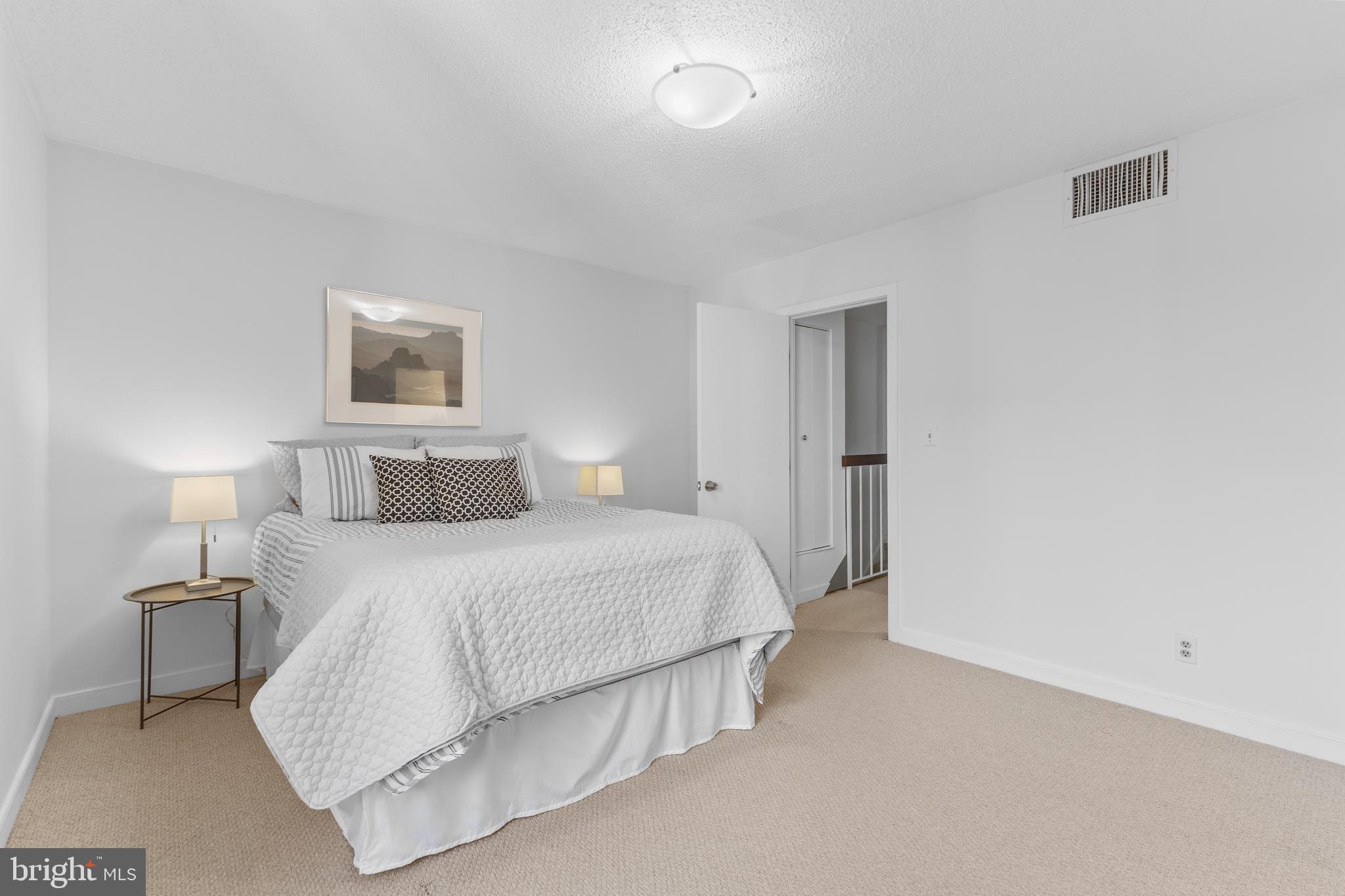 1099 22nd Street Northwest, Unit 807 Washington, DC 20037 - Photo 12 of 34 a bedroom with a bed and a night stand