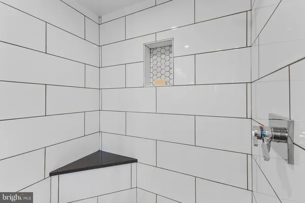 a bathroom with a double vanity sink a mirror and a bathtub