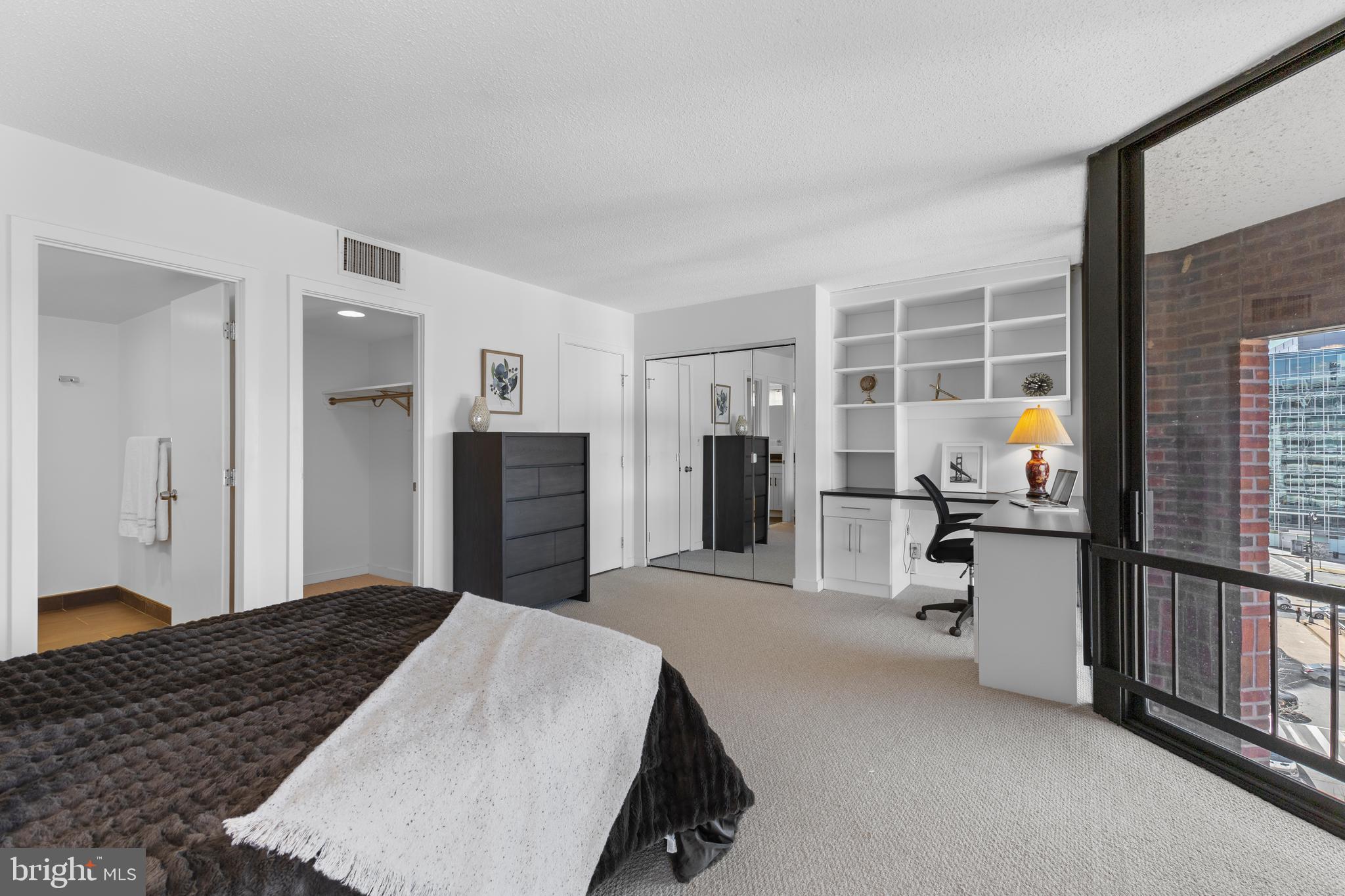1099 22nd Street Northwest, Unit 807 Washington, DC 20037 - Photo 22 of 34 a bedroom with a bed and a large mirror