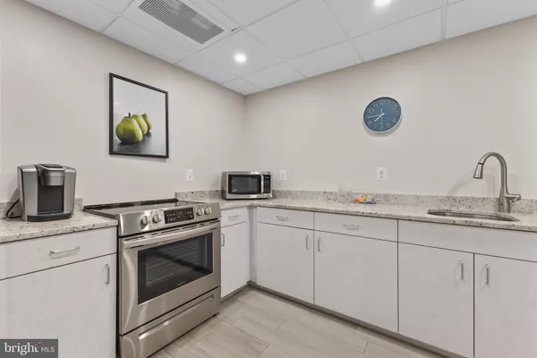 a large kitchen with a table and chairs