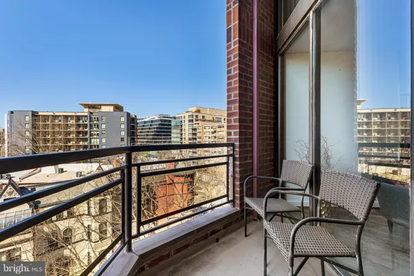 a view of balcony with a couple of chairs