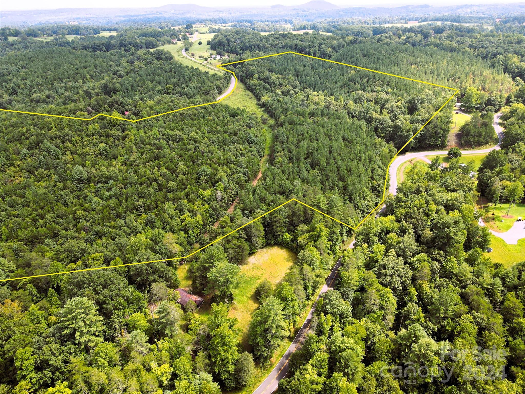 5157 Rhoney Road Connelly Springs, NC 28612 - Photo 16 of 29 an aerial view of a houses with a lush green hillside
