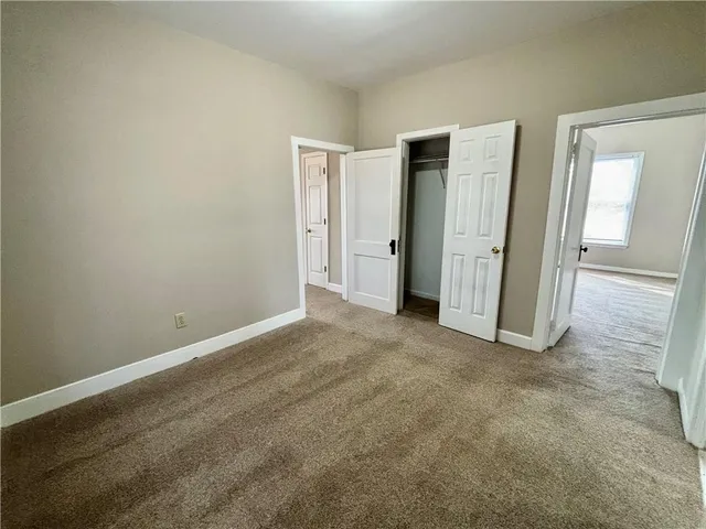 an empty room with closet and closet