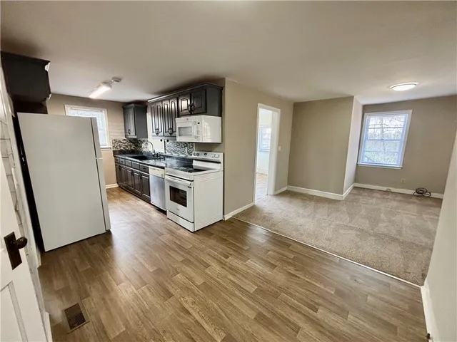 a kitchen with a refrigerator and a sink