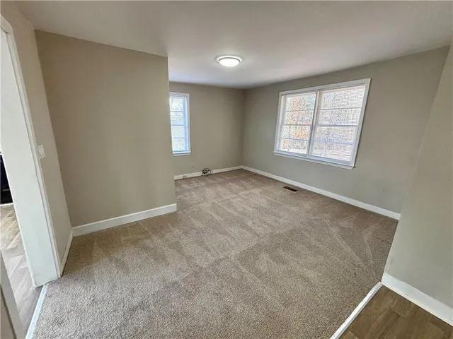 an empty room with a empty space and windows