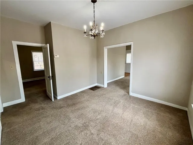 a view of a chandelier in big room and a chandelier