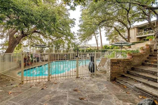 a view of a yard with wooden fence