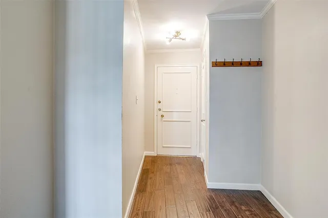 a view of hallway with wooden floor
