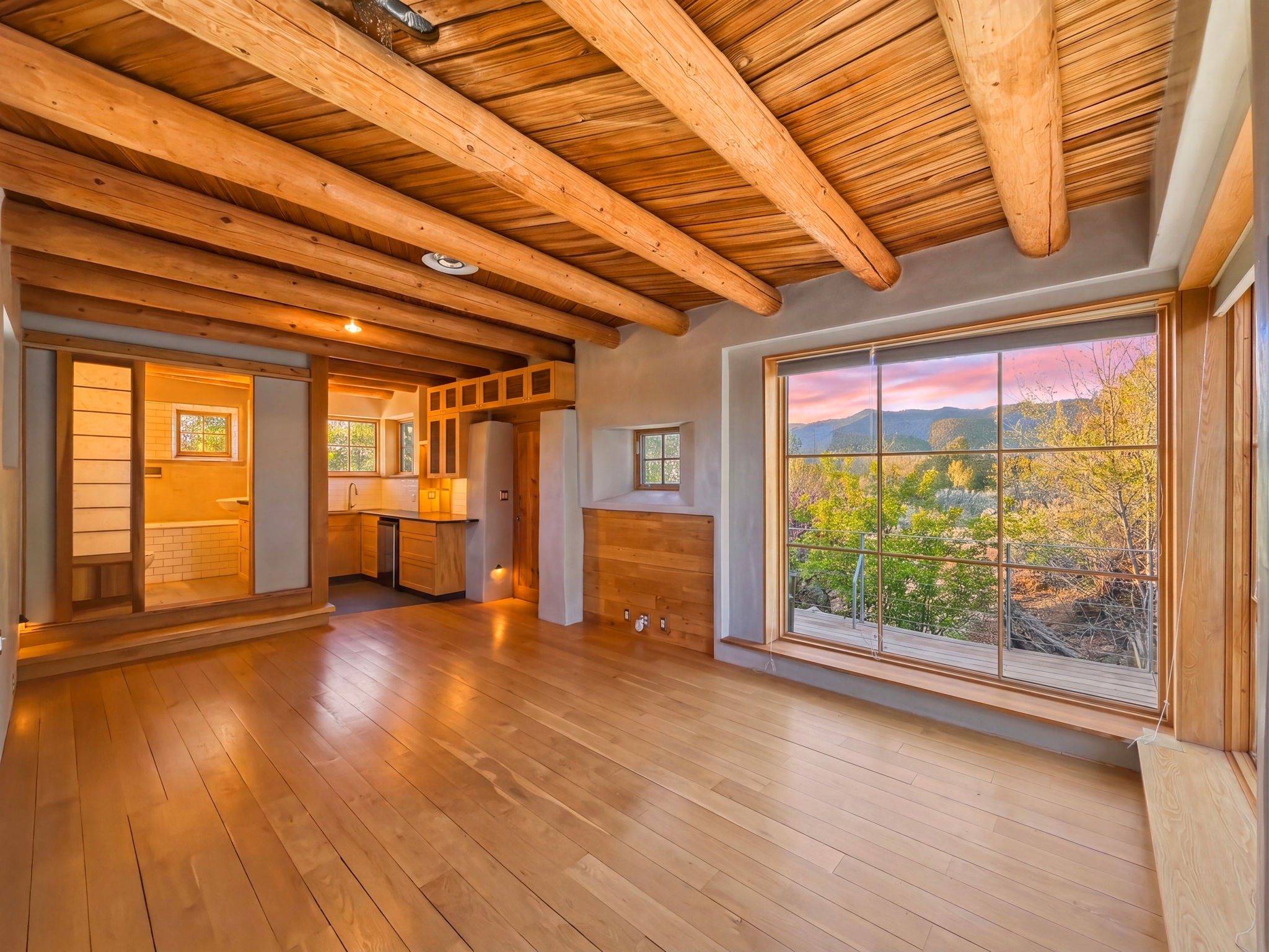 1692 Upper Canyon Road Santa Fe, NM 87501 - Photo 38 of 52 The Private Retreat aglow at dusk, bathroom concealed behind styled sliding doors.