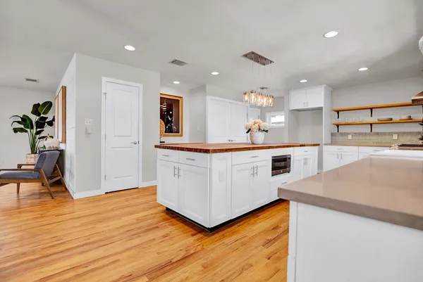 a kitchen with a sink cabinets and wooden floor