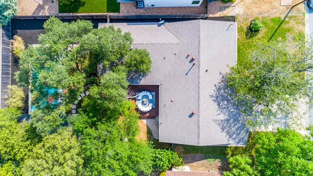 an aerial view of a house with a yard and garden