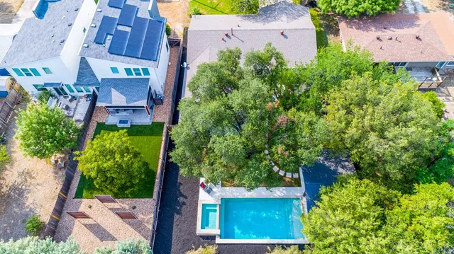 an aerial view of a house with a yard and garden