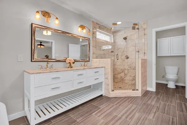 a bathroom with a sink mirror and a toilet