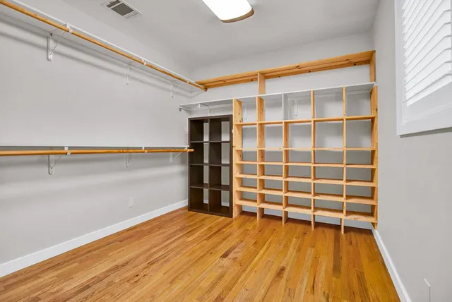 a view of a room with wooden floor and shoes