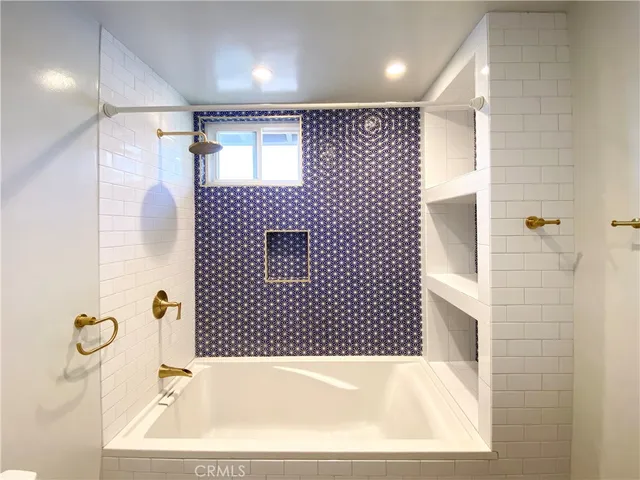 a bathroom with a bathtub and a shower