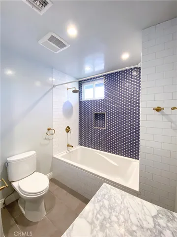 a bathroom with a toilet a sink and bathtub