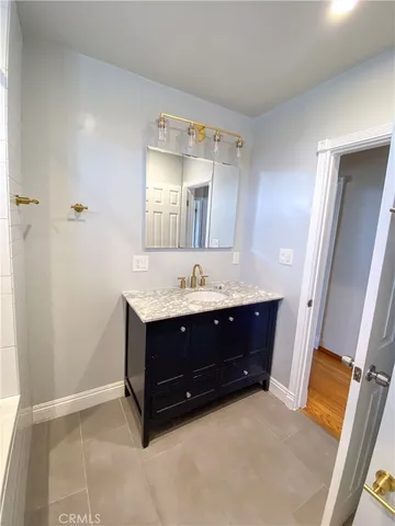 a bathroom with a sink vanity and mirror