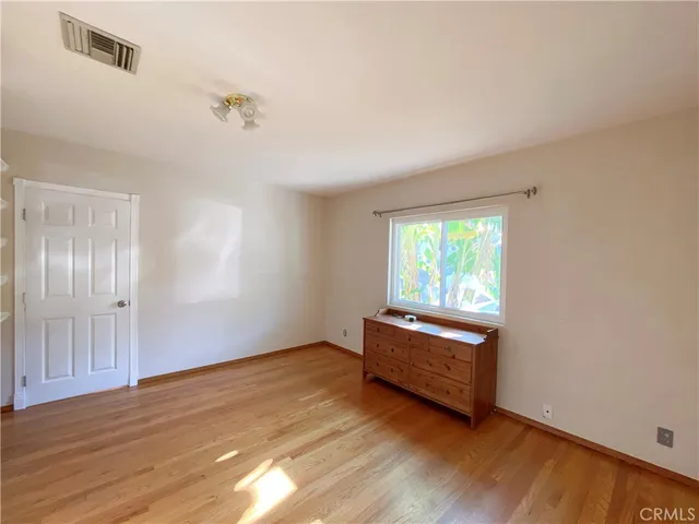 a view of room with wooden floor and window