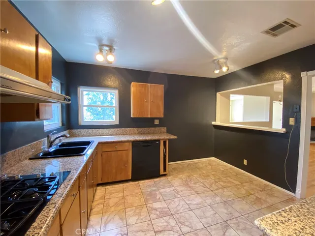 a kitchen that has a sink and a stove in it