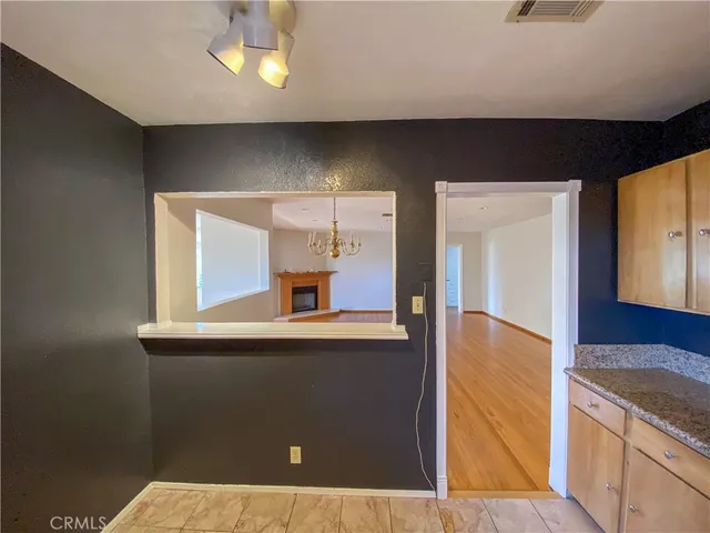 a view of a kitchen with a refrigerator and a sink