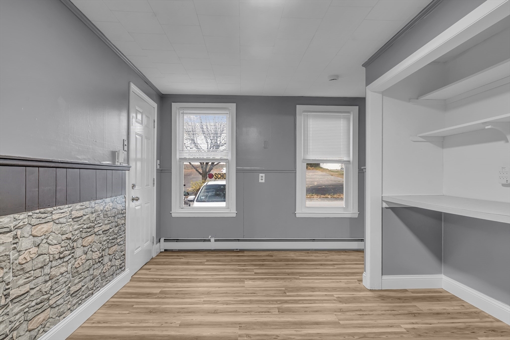 13 Pacific Street, Unit 1 Fitchburg, MA 01420 - Photo 12 of 14 a view of an empty room with wooden floor and window