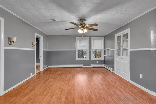 a view of a livingroom with a hardwood floor and a ceiling fan