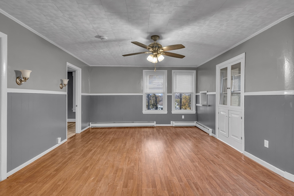 13 Pacific Street, Unit 1 Fitchburg, MA 01420 - Photo 5 of 14 a view of a livingroom with a hardwood floor and a ceiling fan