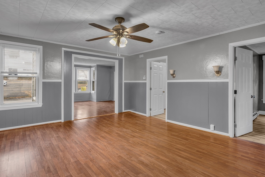 13 Pacific Street, Unit 1 Fitchburg, MA 01420 - Photo 6 of 14 a view of an empty room with wooden floor and a window