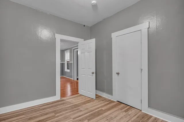 wooden floor in a hall with an empty room