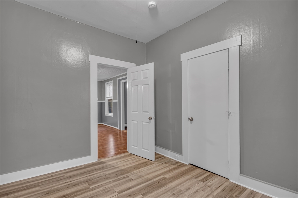 13 Pacific Street, Unit 1 Fitchburg, MA 01420 - Photo 8 of 14 wooden floor in a hall with an empty room