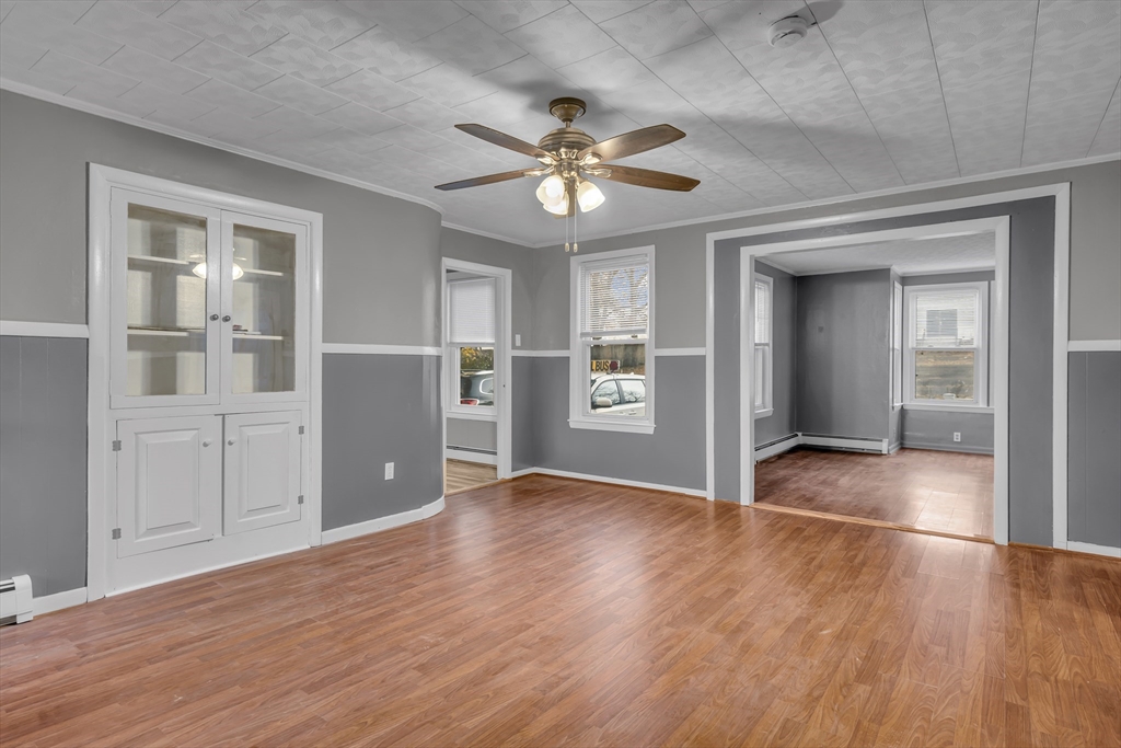 13 Pacific Street, Unit 1 Fitchburg, MA 01420 - Photo 10 of 14 a view of an empty room with window and wooden floor