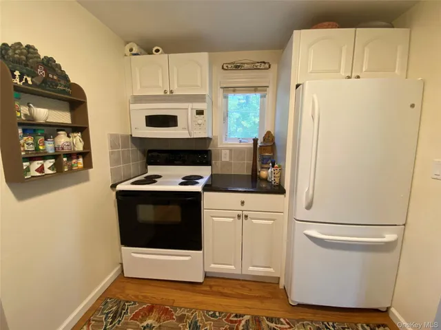 a kitchen with stainless steel appliances a refrigerator a stove a microwave and cabinets