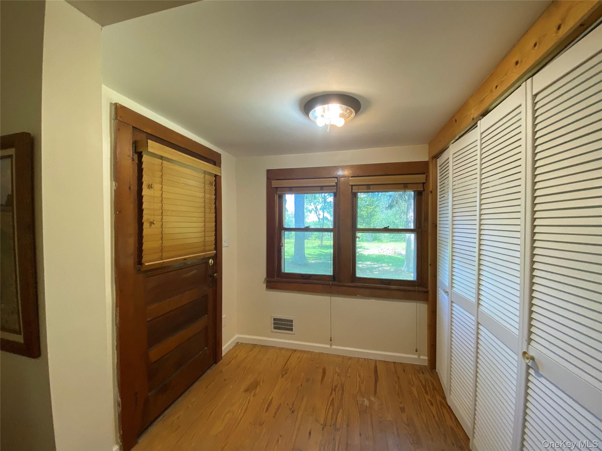 13 Fisher Road Cochecton, NY 12726 - Photo 19 of 32 an empty room with wooden floor and windows
