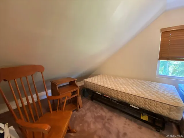 a bedroom with furniture and a window